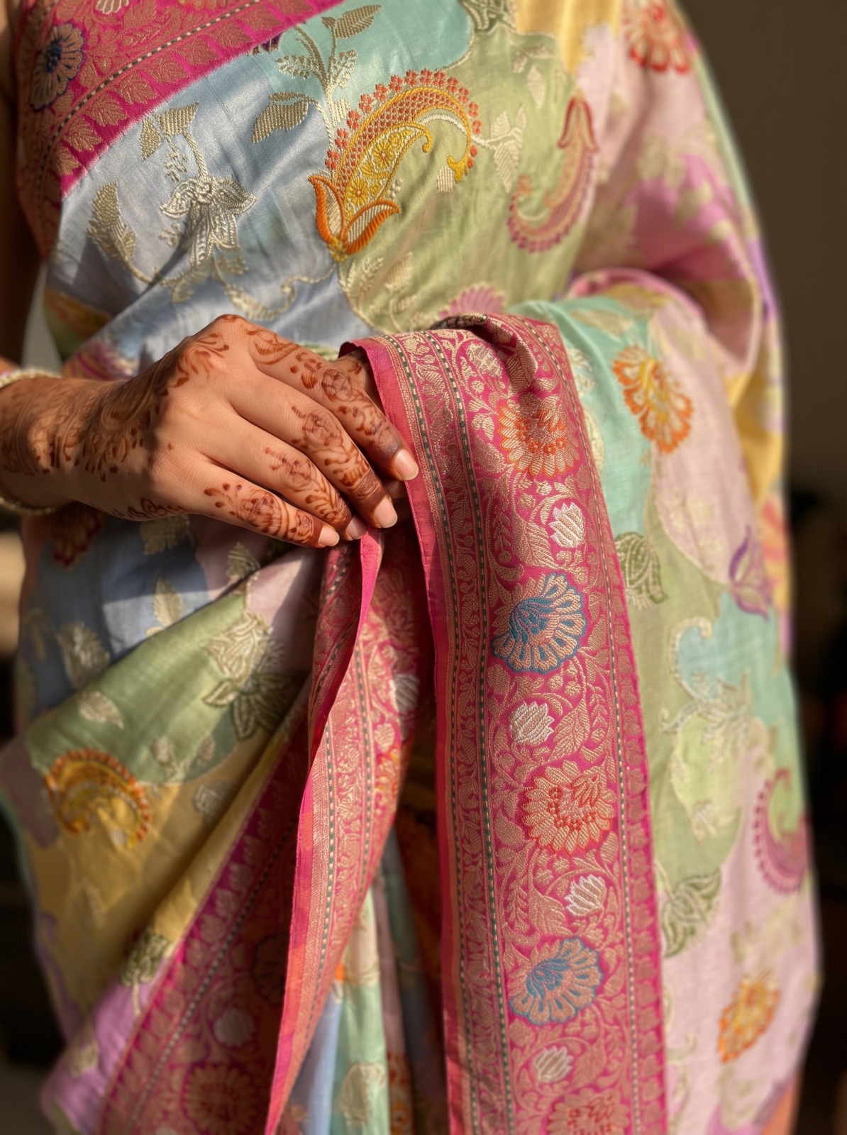 Close up of a pure Moonga silk saree showing intricate floral patterns